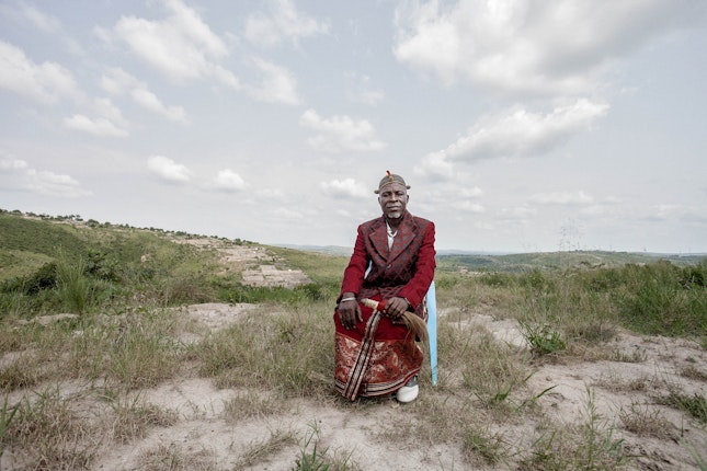 A man sitting in a chair in open land