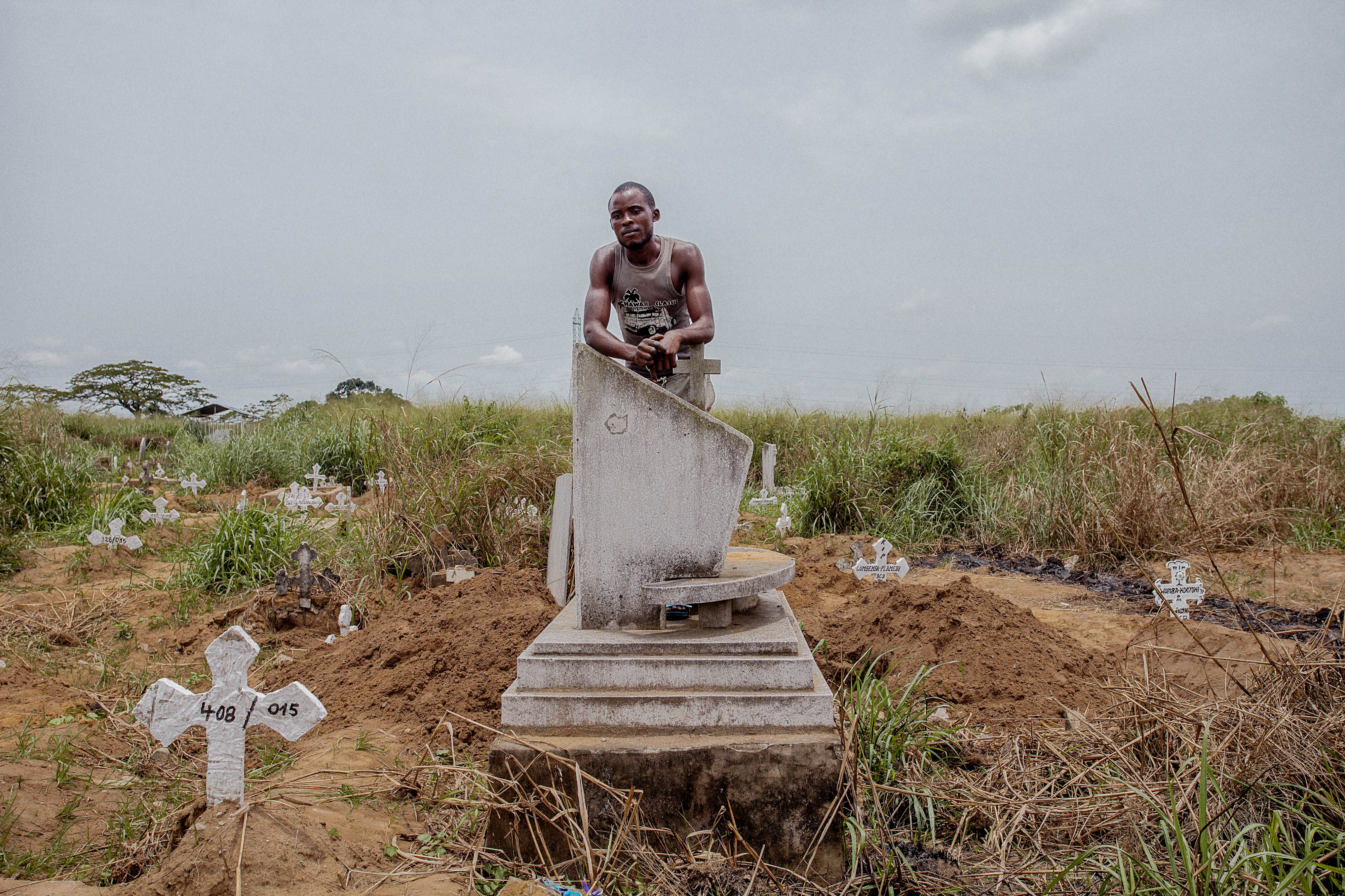 A man leaning on a tombstone