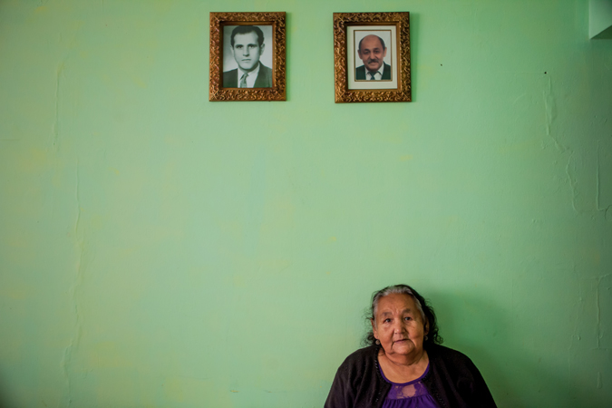 Woman sitting down under two pictures