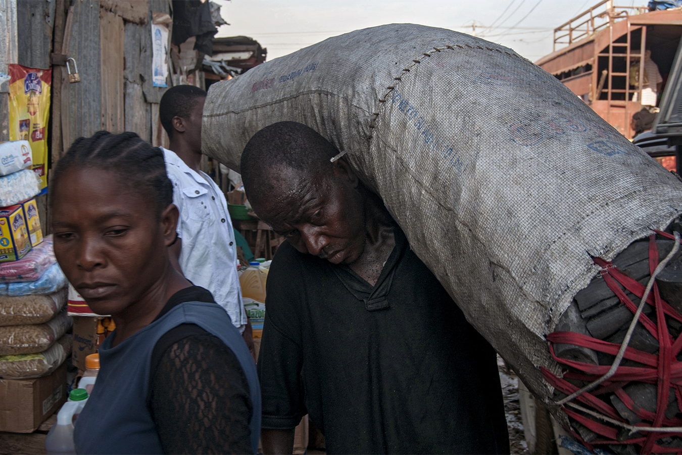 Man carries bag of coal