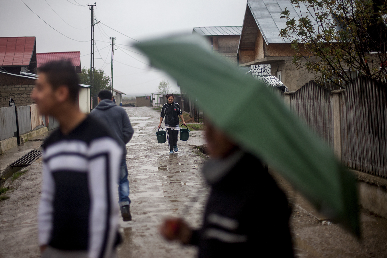 Woman carries buckets in the street