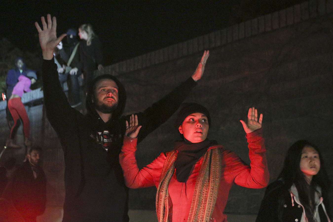 Woman and man with hands up