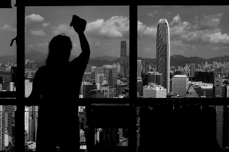 A woman at the window of a tall building