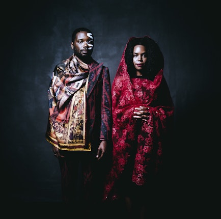 From the series “After Migration” James Jean and Patrice Worthy, photographed in New York City, United States, 2016. Although they have made America their home, the new generation reflects their parents’ storied histories through traditional clothing. Jean and Worthy wear original designs from the fashion line Ikiré Jones by Walé Oyéjidé, a socially aware design company that marries West African aesthetics and textiles with European silhouettes. Using fashion photography and featuring models who are themselves migrants, he aims to elevate and humanize migrants’ stories within visual culture and subvert mainstream media representations. Photo credit: © Rog Walker for Ikiré Jones A man and woman photographed in a studio