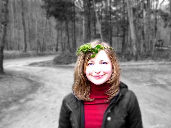 Girl standing in the middle of a road, smiling