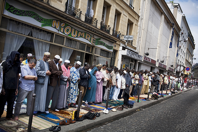 Worshippers lining up to pray on sidewalk