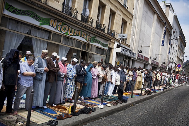 Worshippers lining up to pray on sidewalk