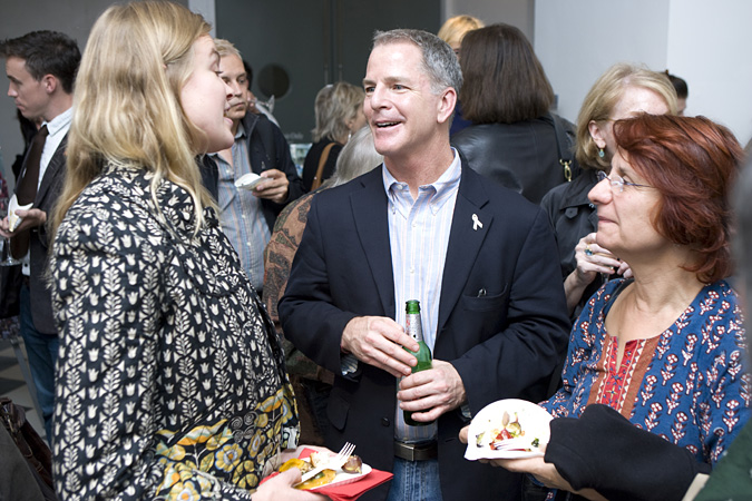 Larry Siems talking to guests at a reception