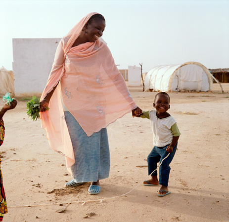 Woman holding a boy's hand