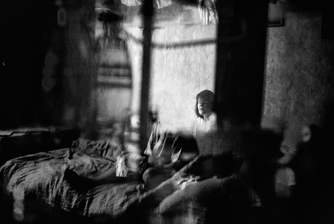 Woman sitting on bed