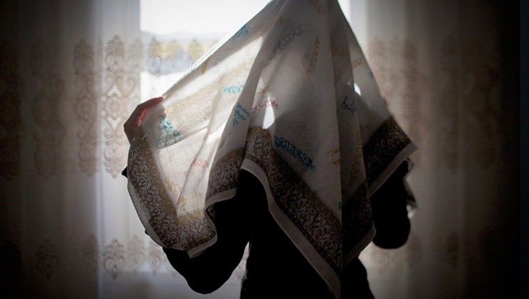A young woman with her face covered