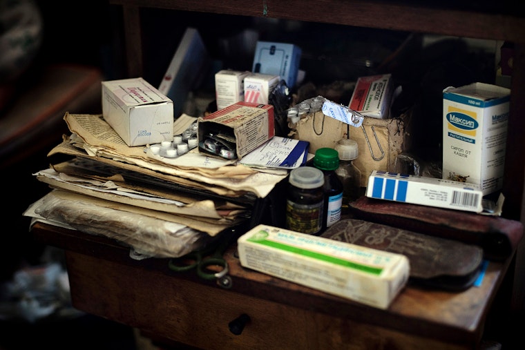 Roza Adreyeva, an 82-year-old woman living in Balykchy, Kyrgyzstan, requires a variety of medication to deal with severe health problems. Photo credit: © Thomas Lekfeldt/VU/Redux Medicines and papers on a desk