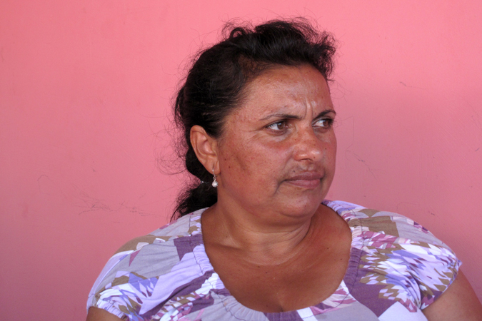 A woman in front of a pink wall