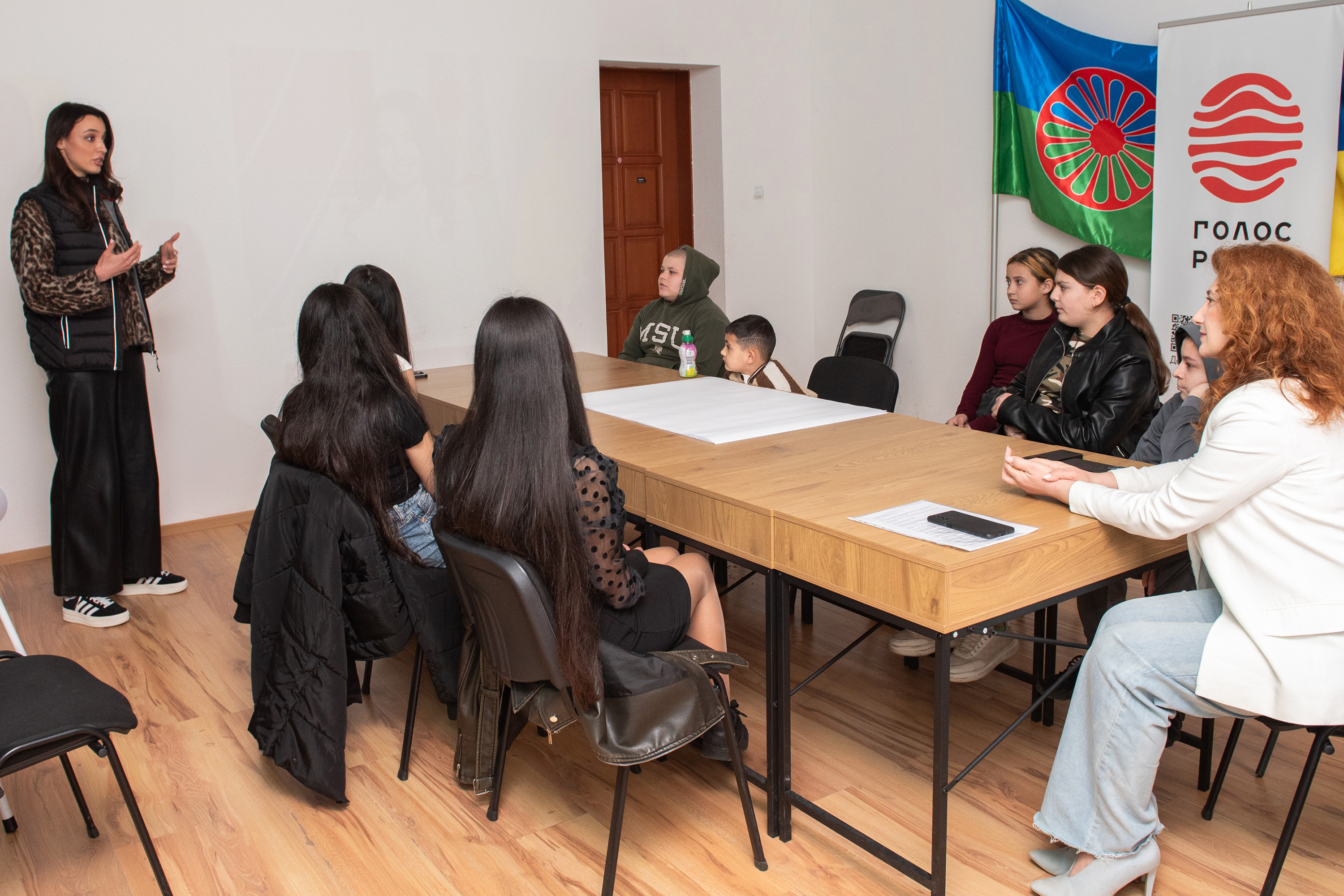Woman speaking to group sitting a