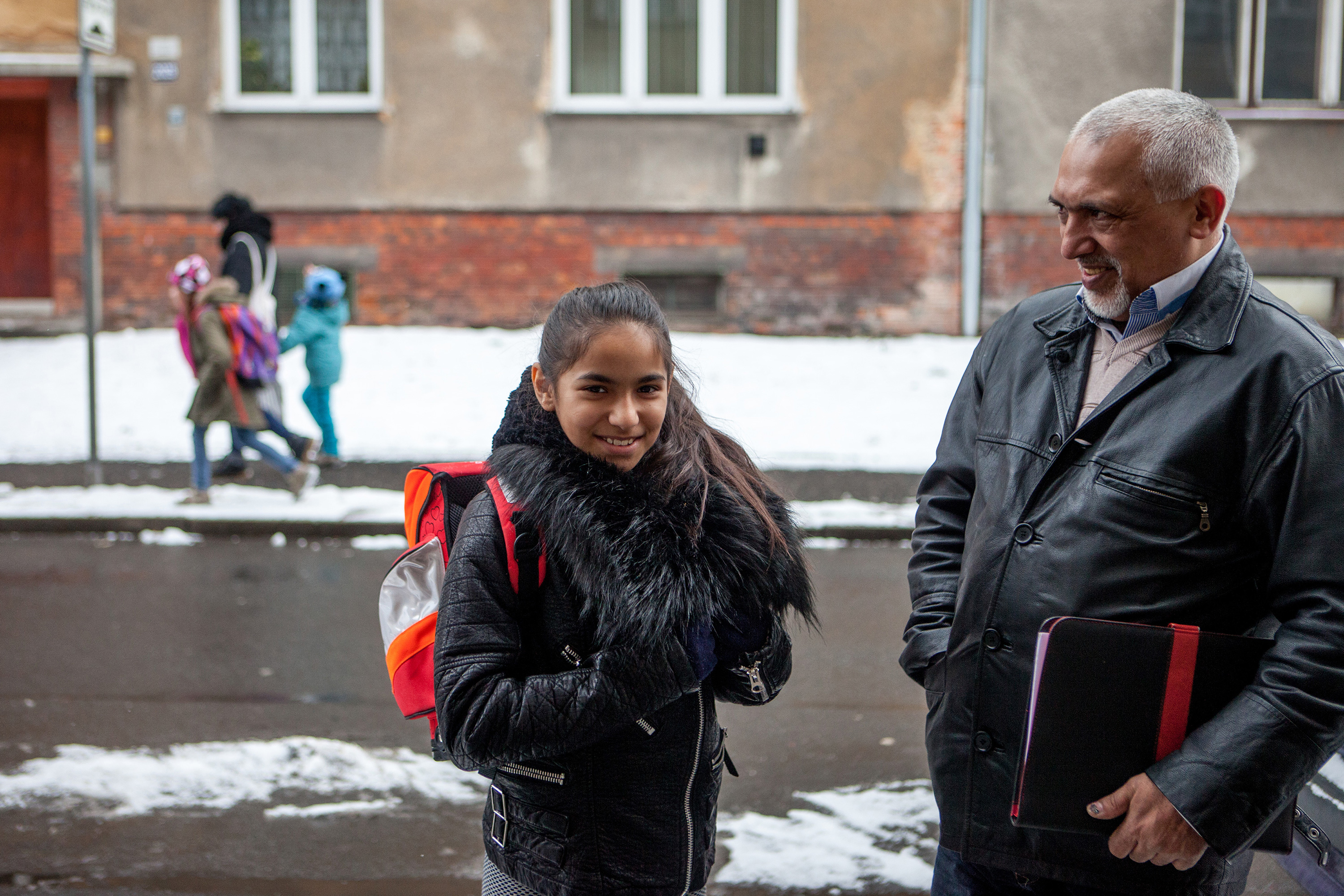 Man and young woman speaking on the street