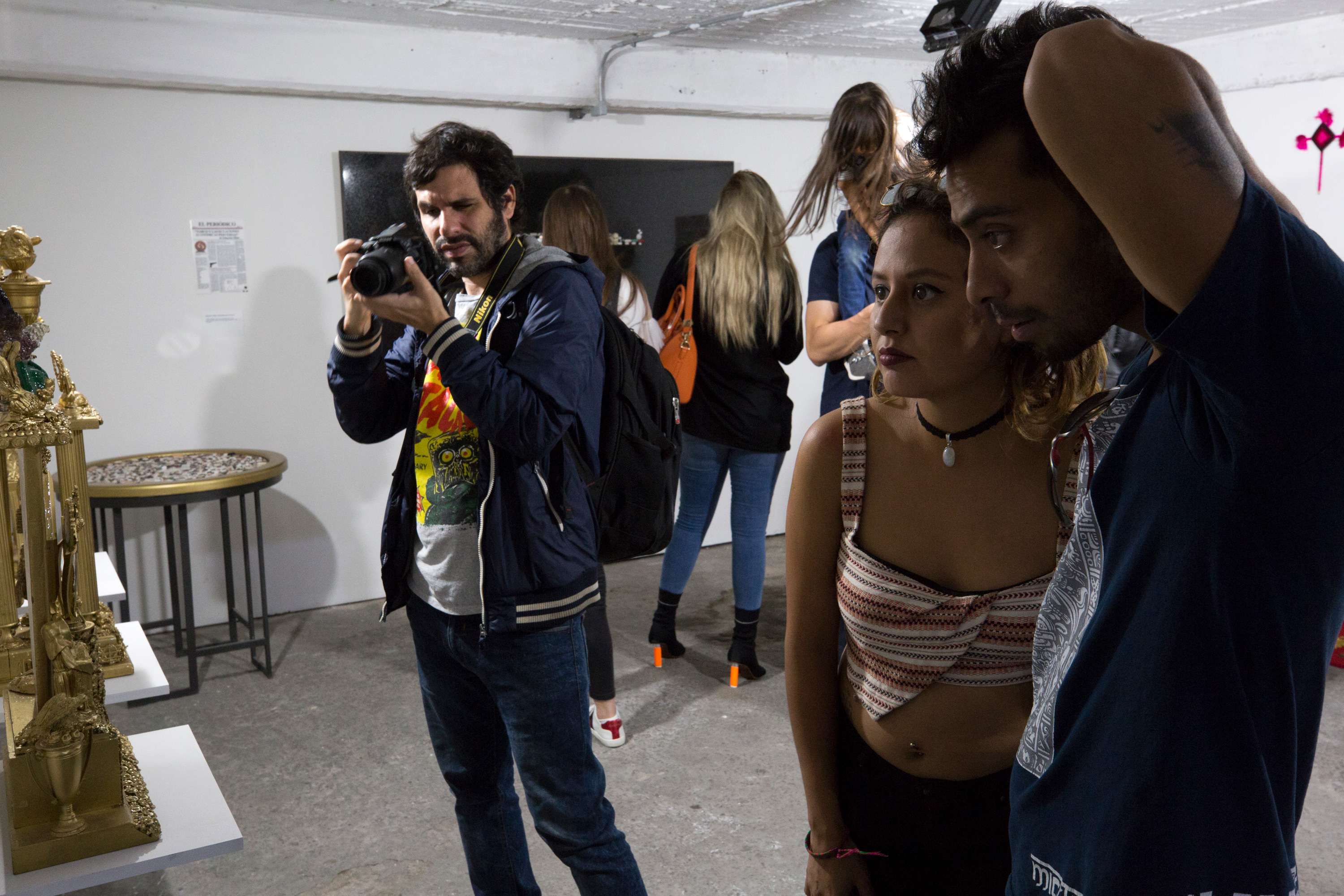 Visitors view sculptures in a gallery space