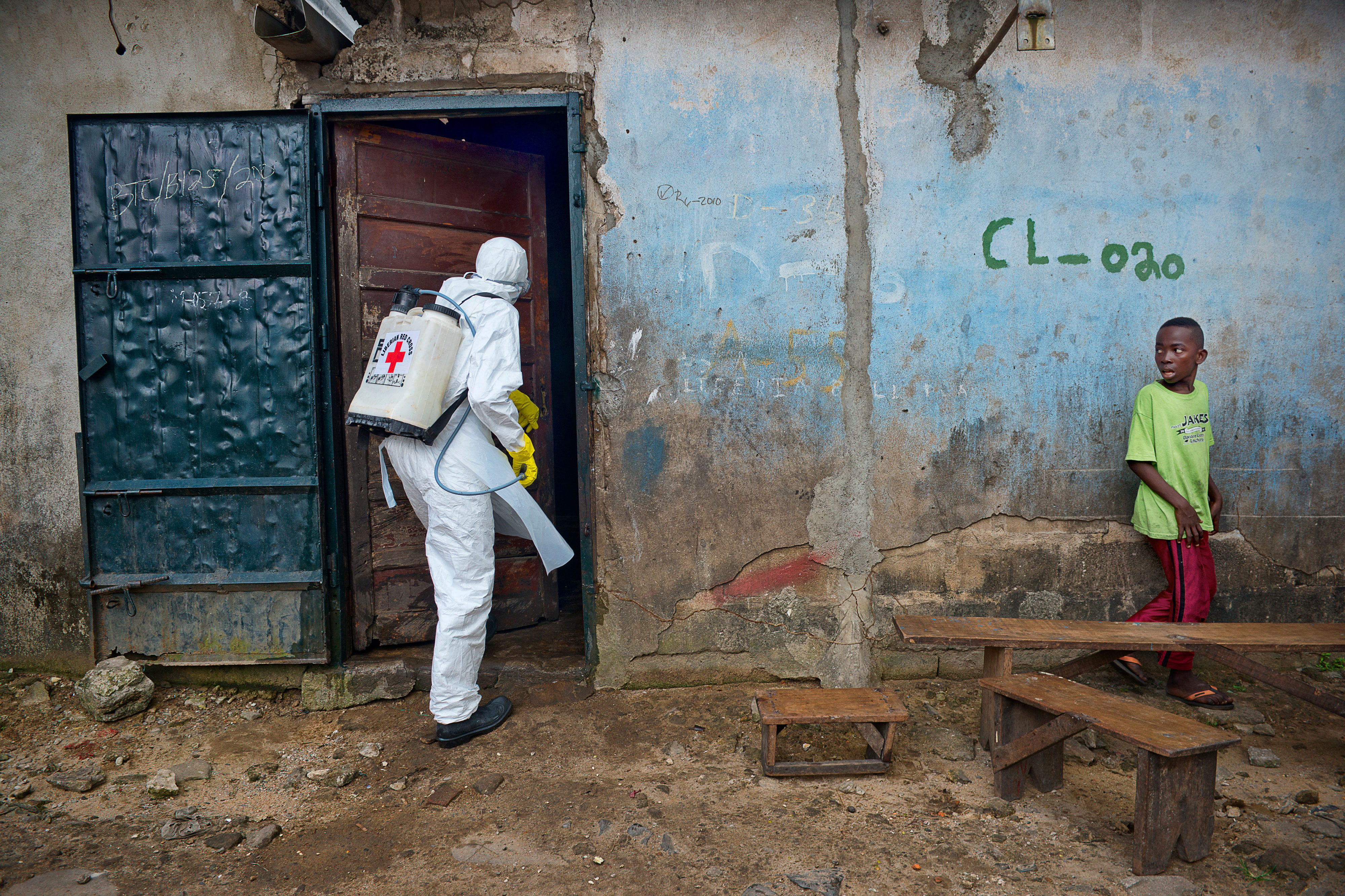 Worker entering a home with disinfection equipment