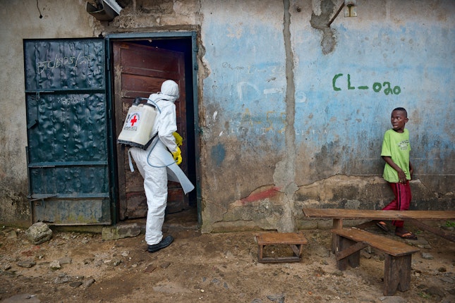 Worker entering a home with disinfection equipment
