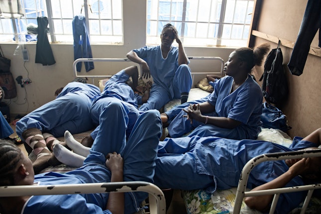Nurses gathered on hospital beds