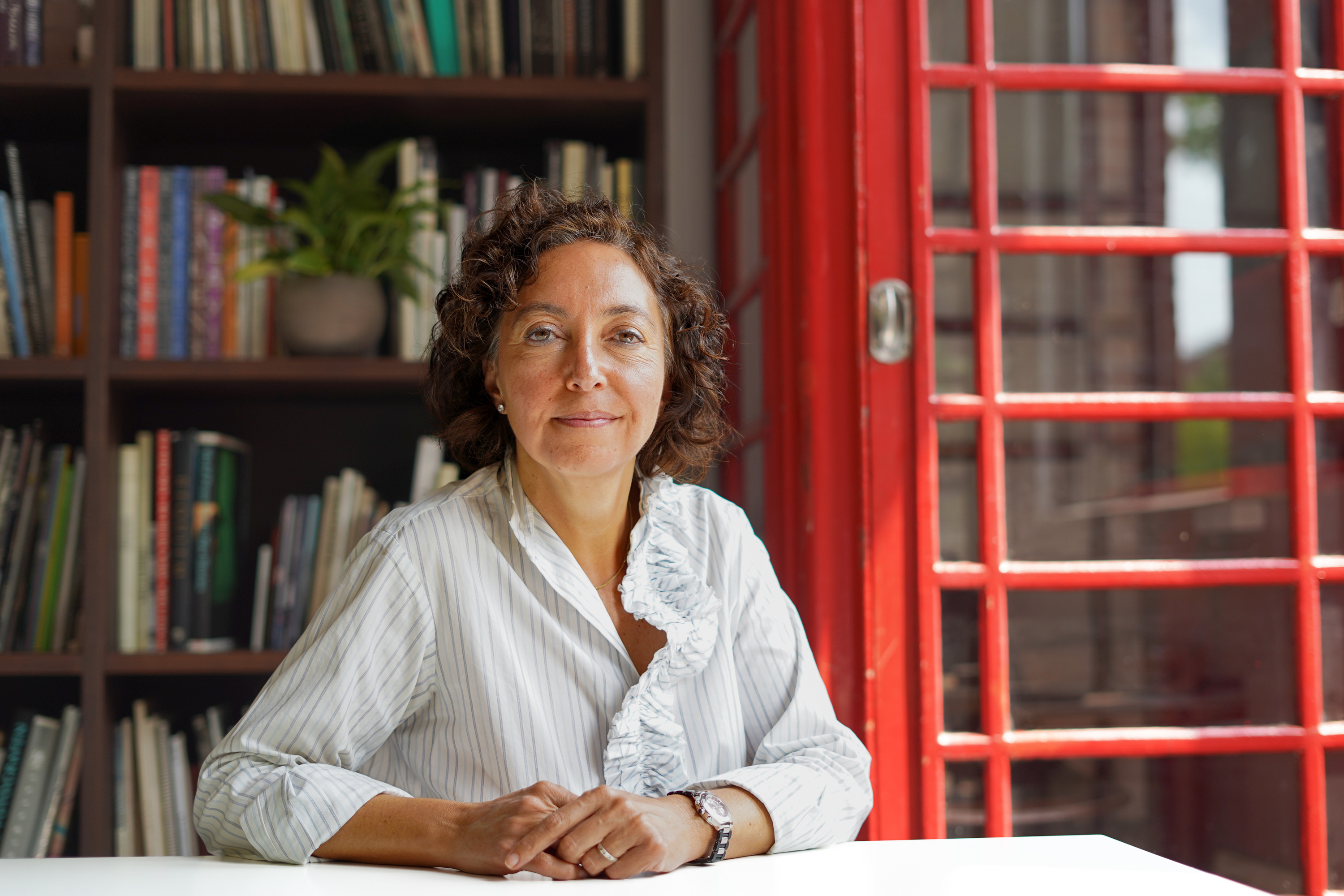 A woman sits at a desk