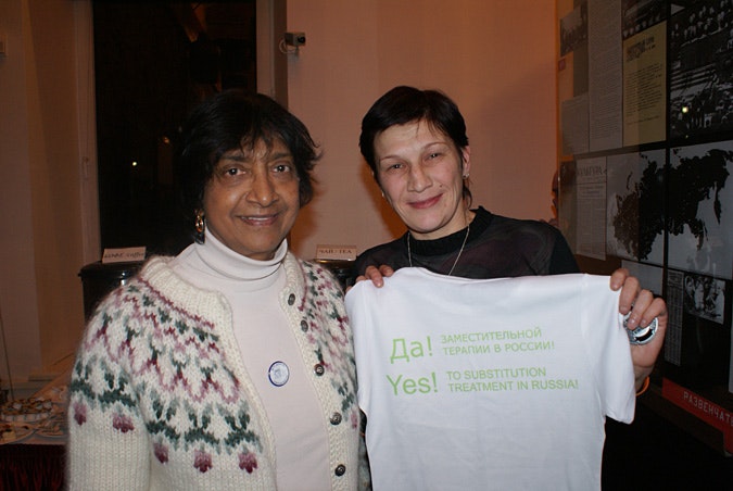 Two HIV activists; one holds a T-shirt