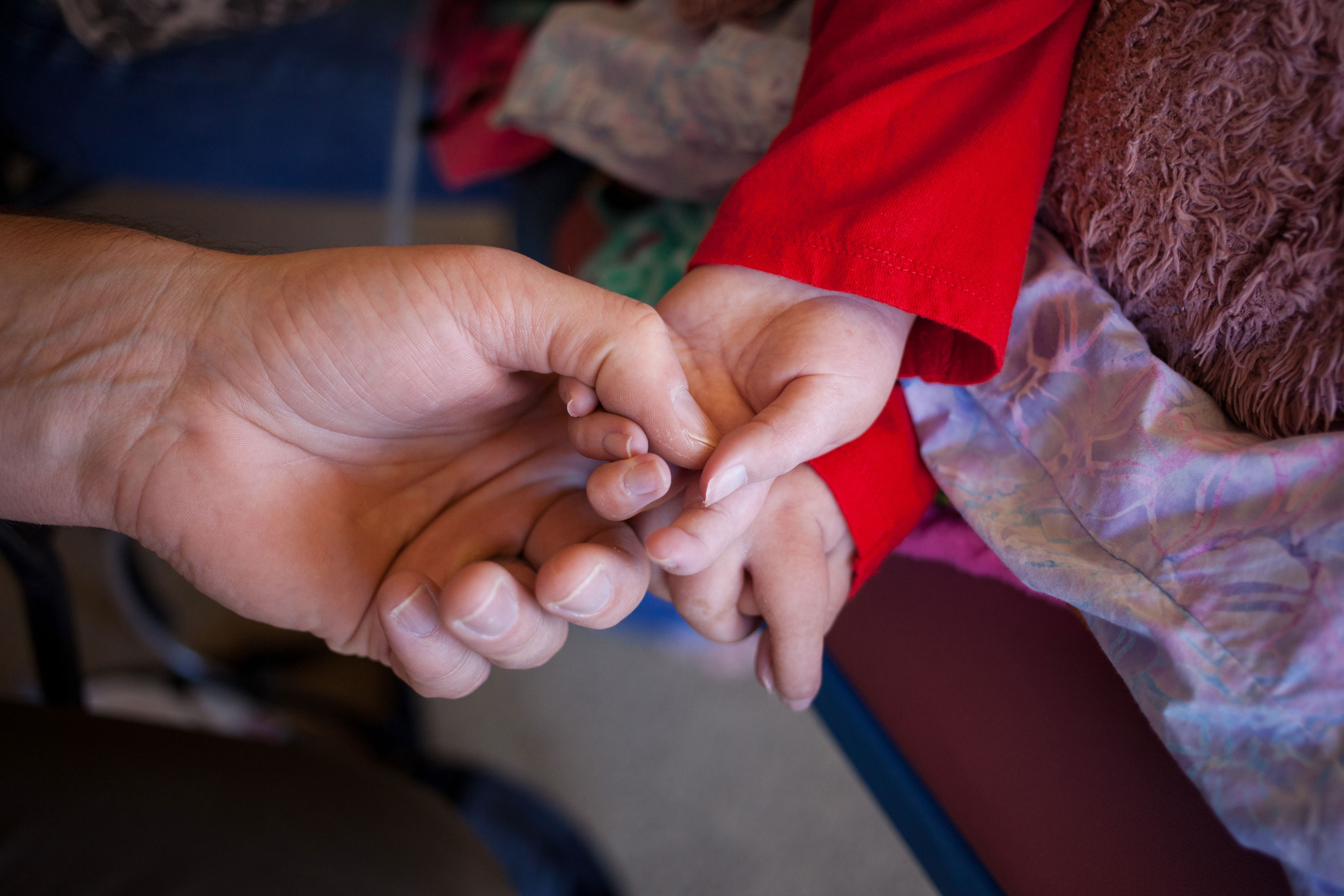 Father and daughter holding hands