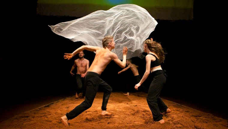 Still from "Prompting the Political Imagination: Art and Open Society." Four performers around a floating sheet