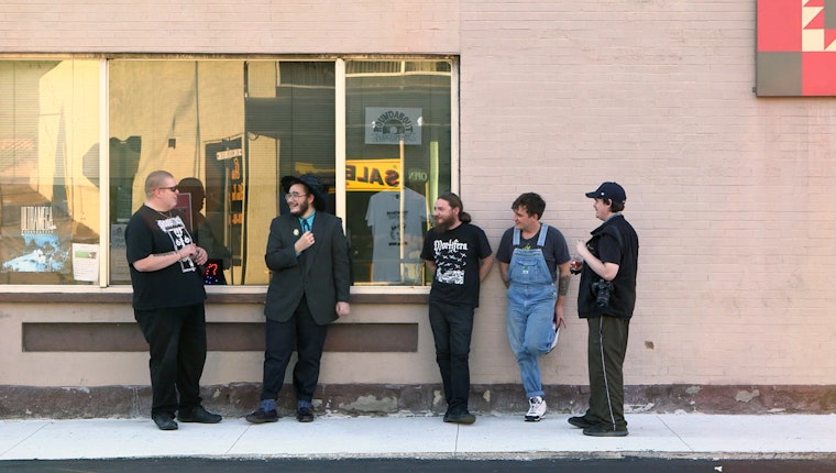 Still from Open Arms in Eastern Kentucky. Oakley Fugate and four others standing by a wall
