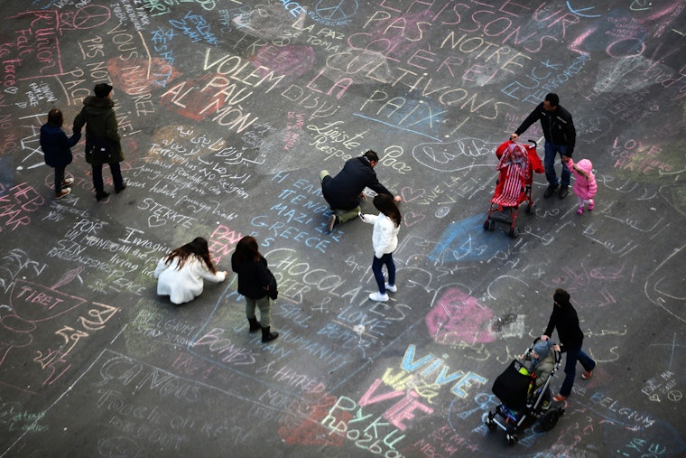 People write chalk messages on the pavement
