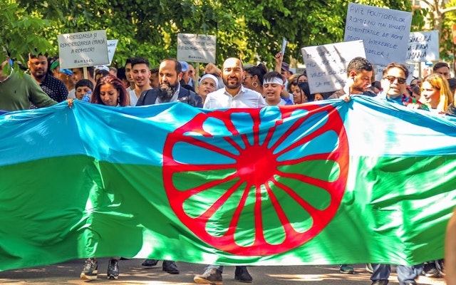 People march with the Romani flag