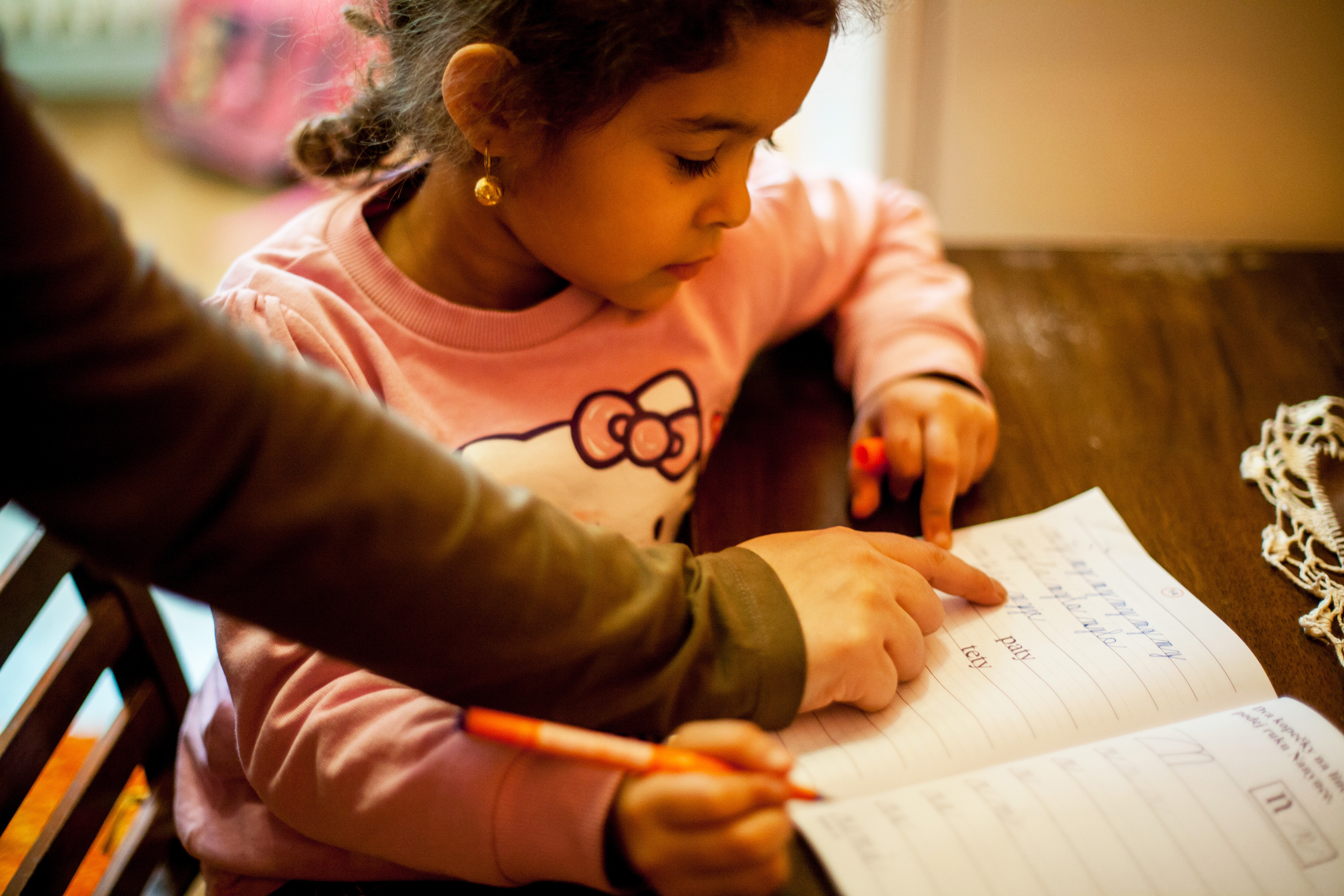 A girl practicing school work in a notebook