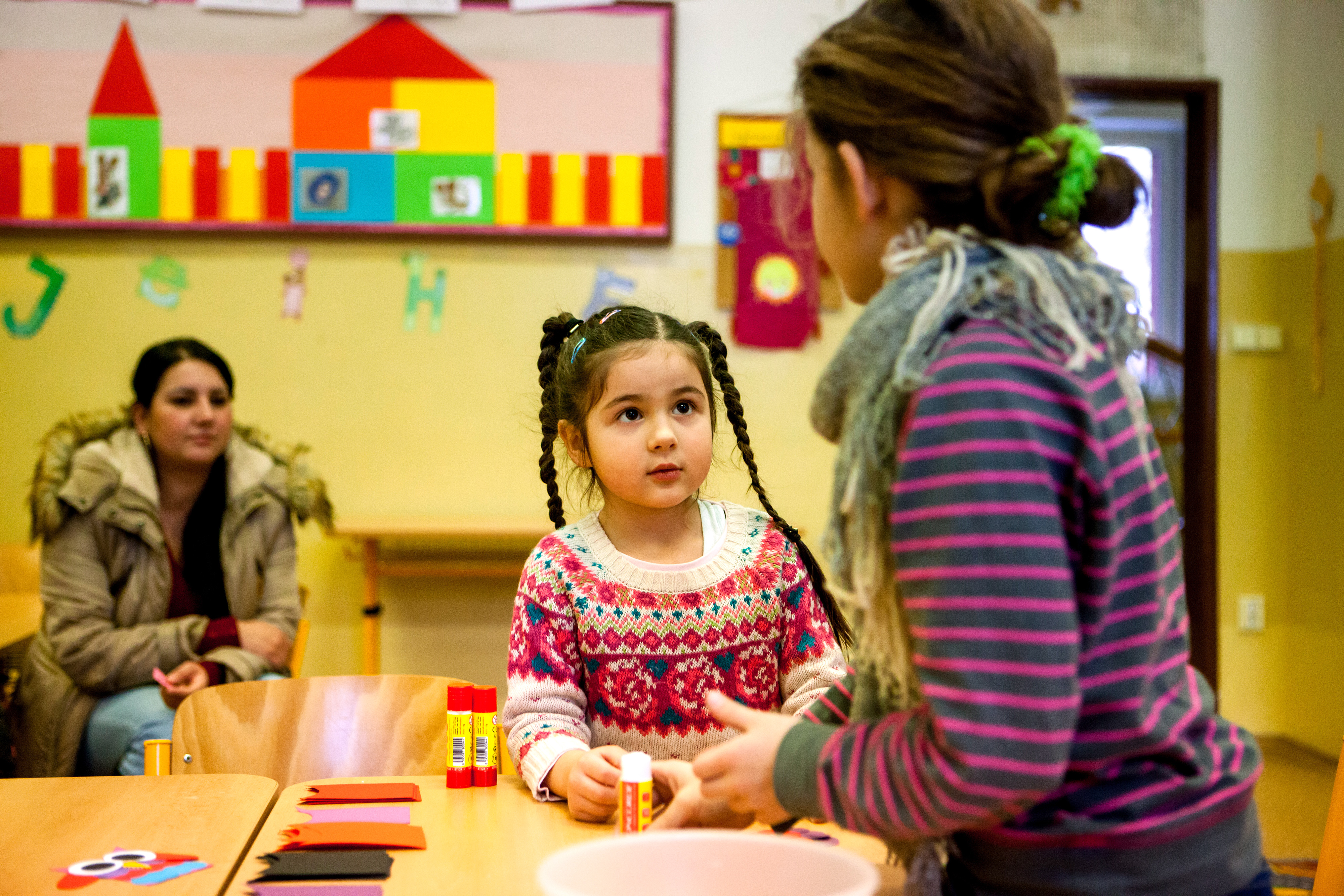 A mother, daughter, and another student in a school classroom