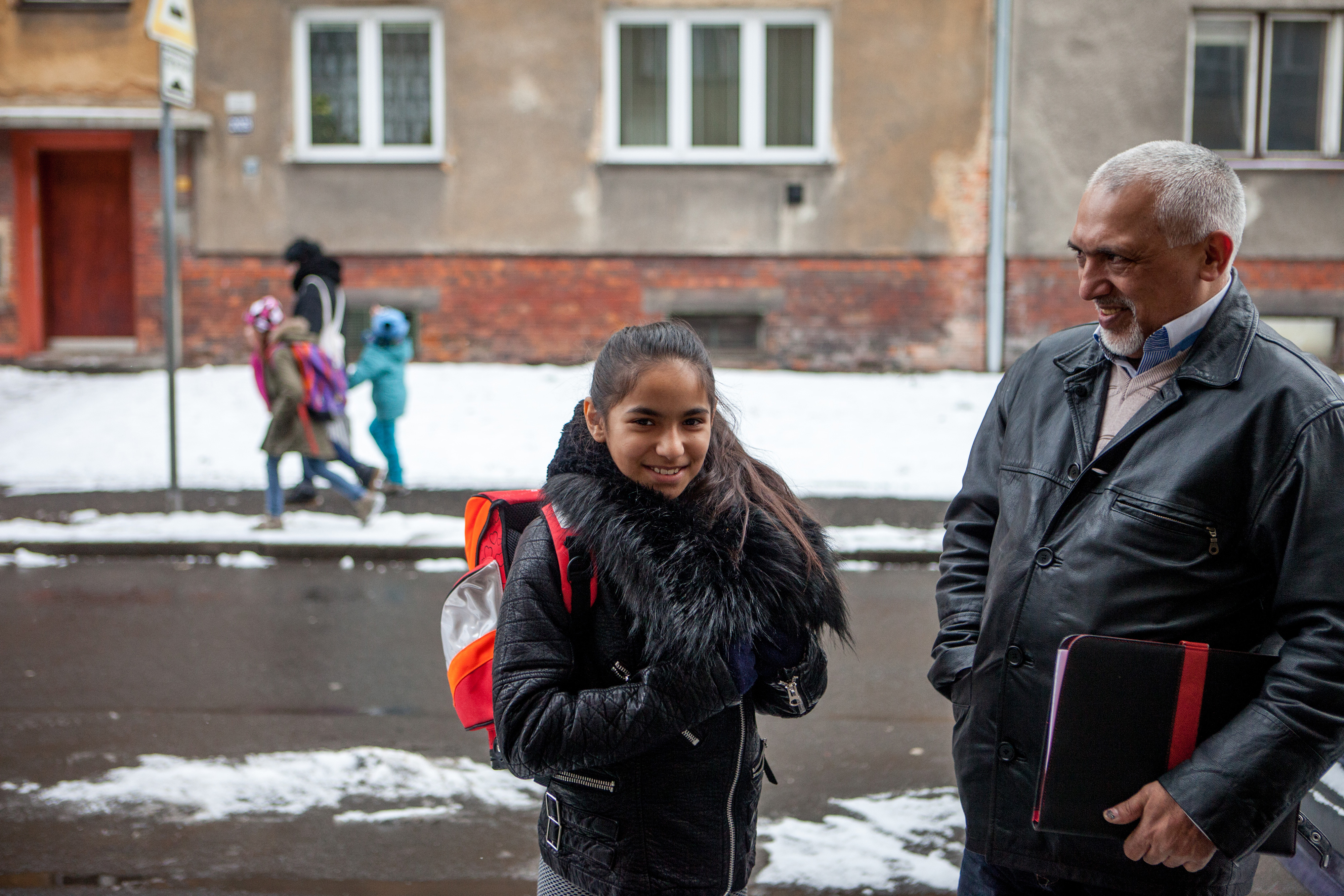 Parents and children on a snow covered street