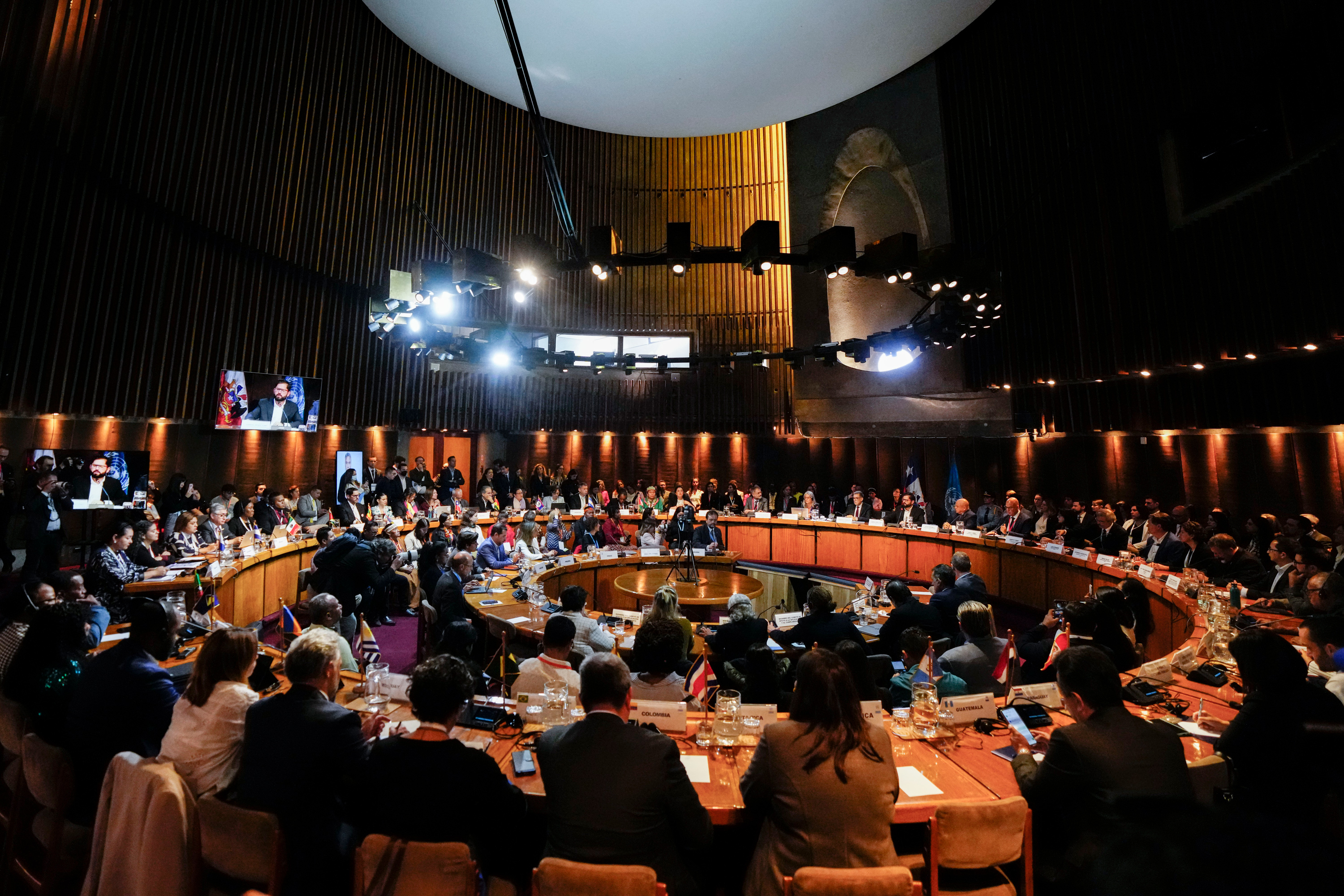 People sitting in a circular shaped meeting room