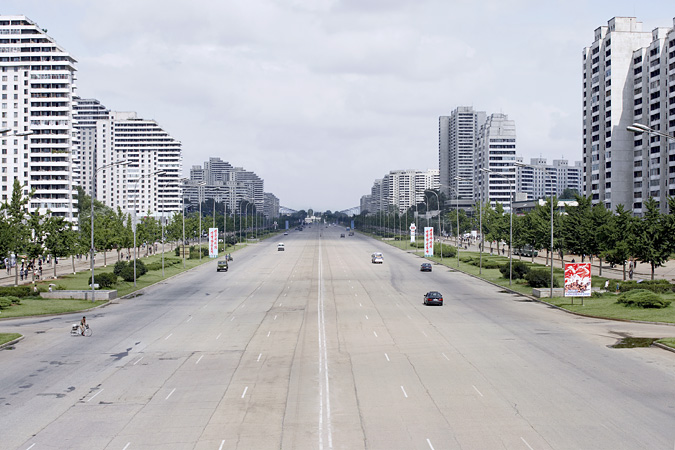 Cars driving down wide street