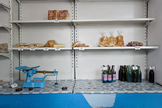 Sparsely filled shelves in a bakery