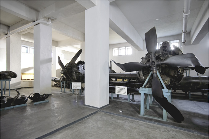 Room with damaged airplane propellers on display