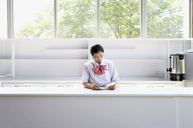 Flight attendant standing behind a counter