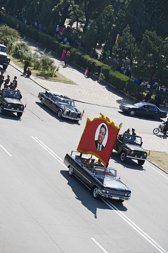 Cars driving in military parade
