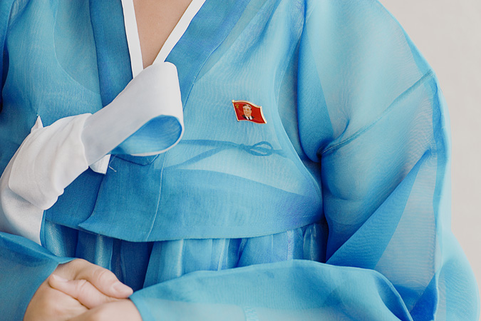 Close up of Kim Il Sung pin on woman’s clothes