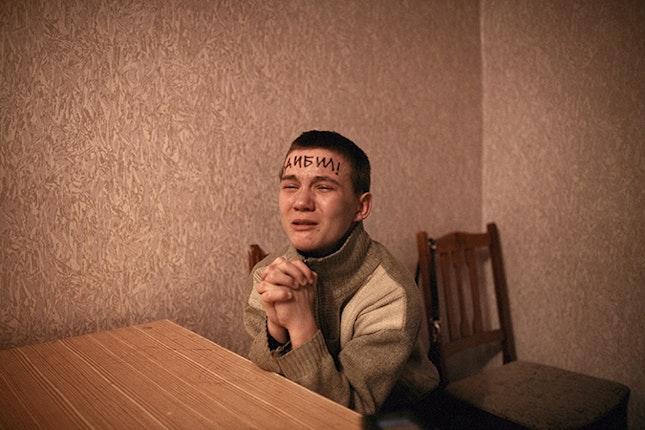 A young man with writing on his forehead