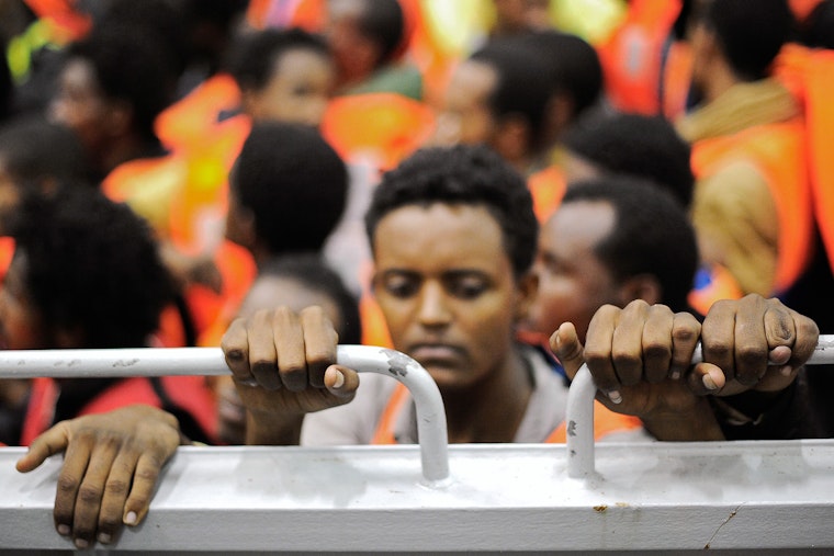 Migrants stand on a landing craft of an Italian naval ship after being rescued in the Mediterranean Sea between the Italian and the Libyan coasts on May 14, 2014. Photo credit: © Giorgio Perottino/Corbis Migrants from Africa on a boat in Italy