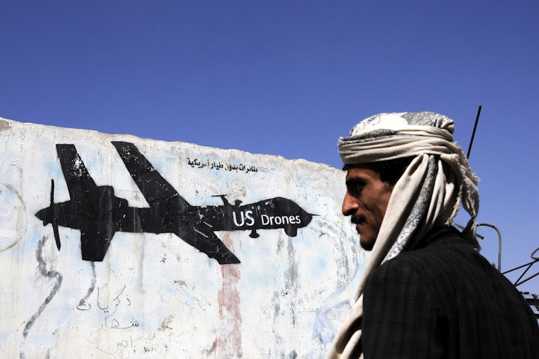 A man in Sanaa, Yemen, walks near a painting of a U.S. drone on January 29, 2017. Photo credit: © Mohammed Mohammed/Xinhua/Redux An aerial unmanned drone painted on a wall