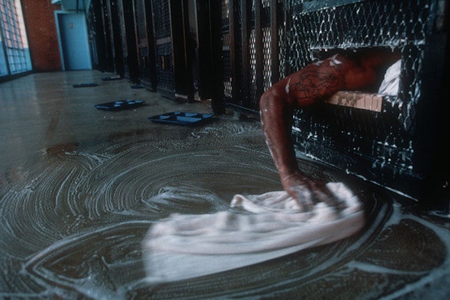 A man’s arm cleaning a floor.