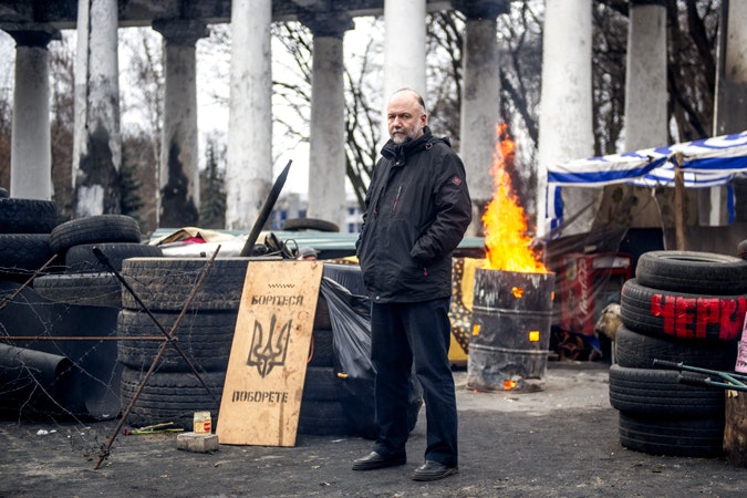 Ukrainian novelist Andrei Kourkov photographed on Khreschatyk Street near the Maidan on March,17 2014 in Kyiv, Ukraine. Photo credit: © Volodymr Shuvayev/AFP/Getty Images A man standing on a street