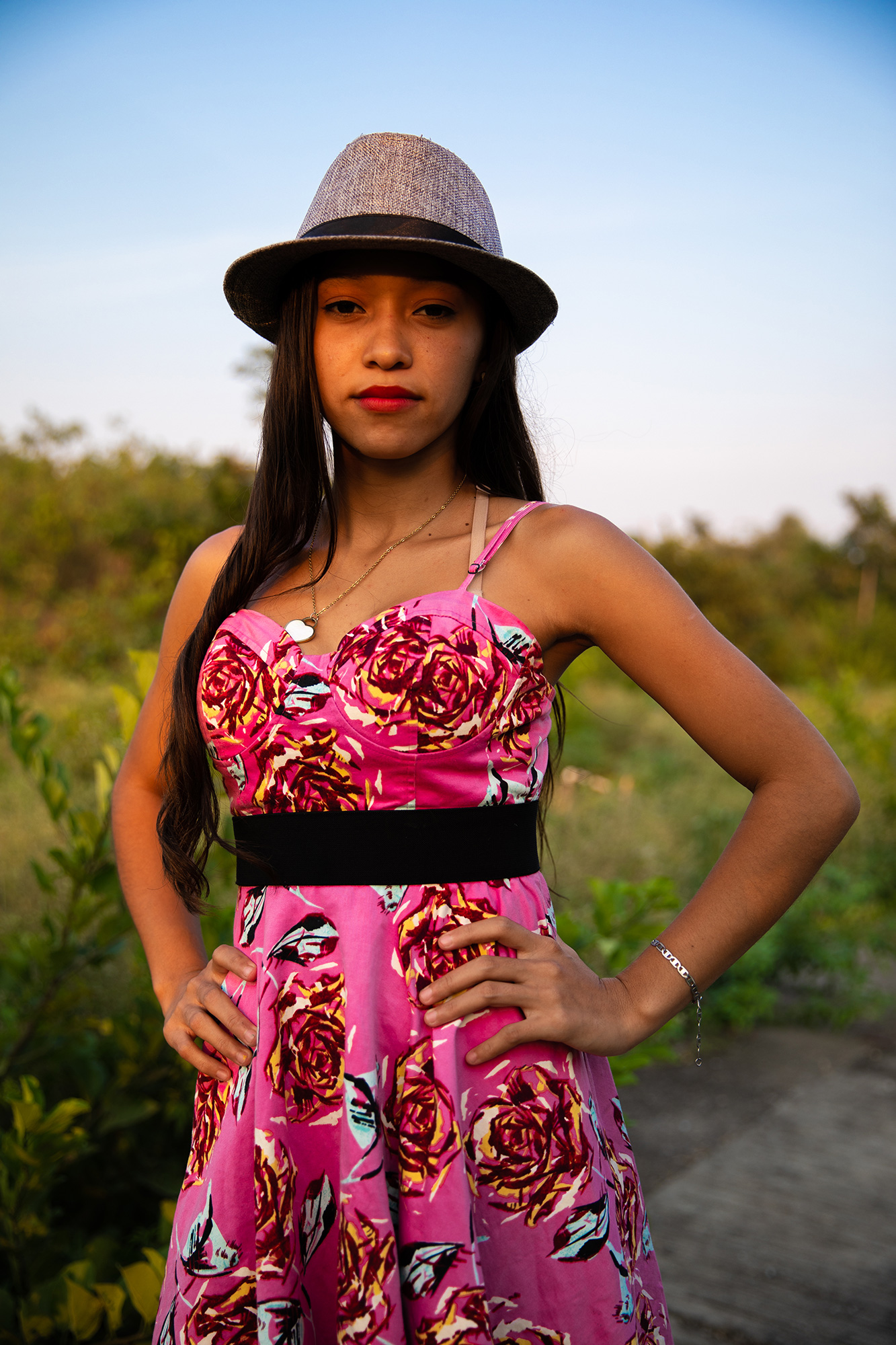 A girl wearing a pink dress and a hat
