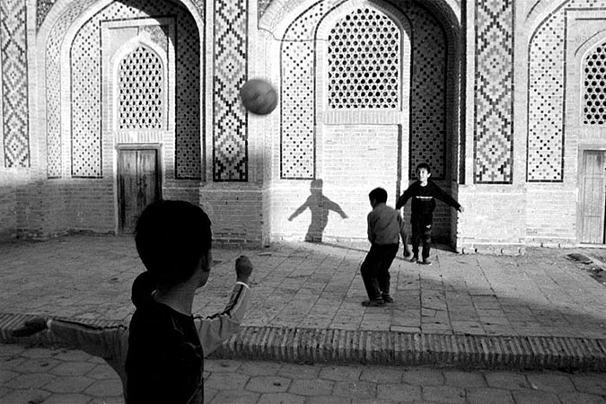 Young children playing with a ball.