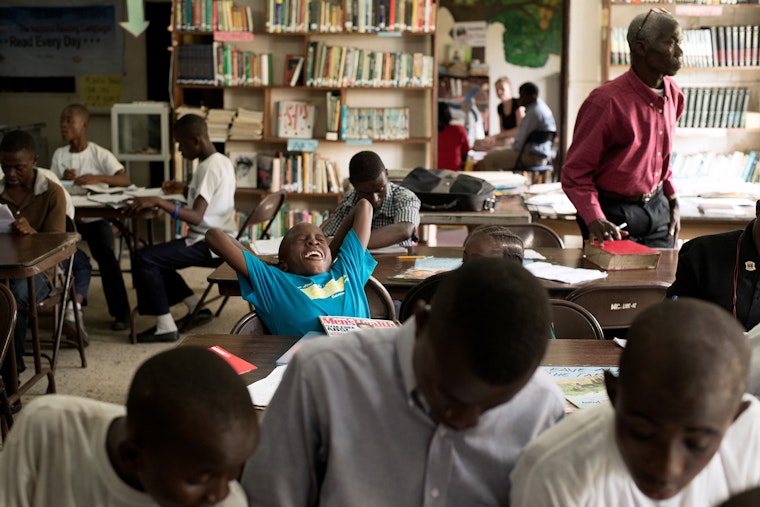 Students assemble in a WeCare Library in downtown Monrovia, Liberia. Photo credit: © Andrea Bruce/NOOR for the Open Society Foundations Students studying in a library in Liberia.