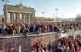 Crowds of people on and around the Berlin Wall