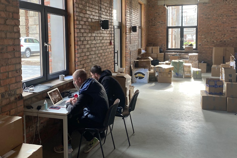 Journalists work in the coworking space of a shelter for displaced Ukrainian journalists run by Lviv Media Forum in Lviv, Ukraine, on April 18, 2022.
© Artur Zajac/Lviv Media Forum Two people at a desk in an office